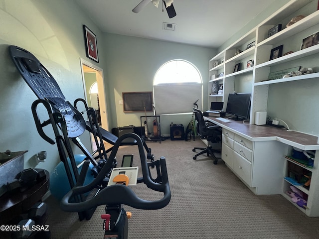 office area with a ceiling fan, light colored carpet, and visible vents