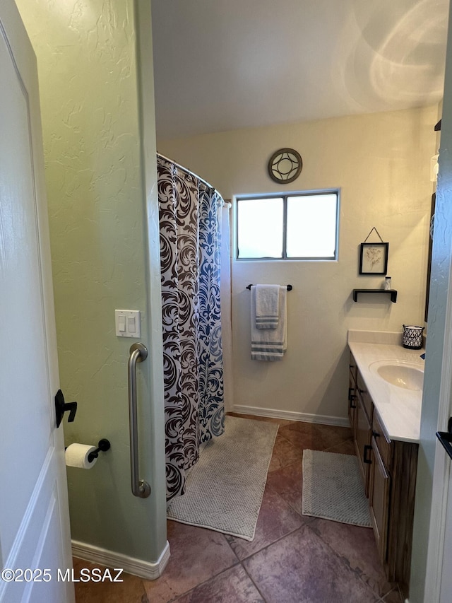 bathroom featuring vanity, baseboards, tile patterned floors, and a shower with curtain