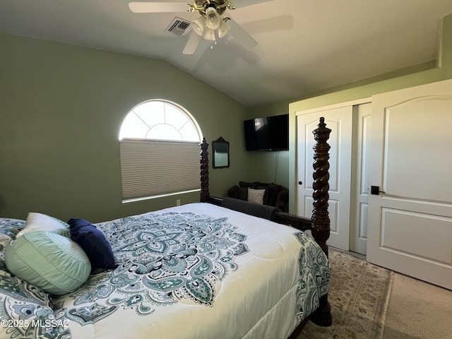 bedroom with ceiling fan, visible vents, carpet floors, vaulted ceiling, and a closet