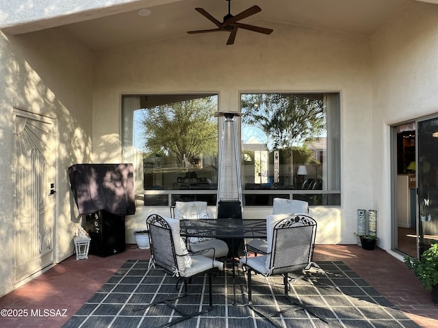 view of patio with outdoor dining space and ceiling fan