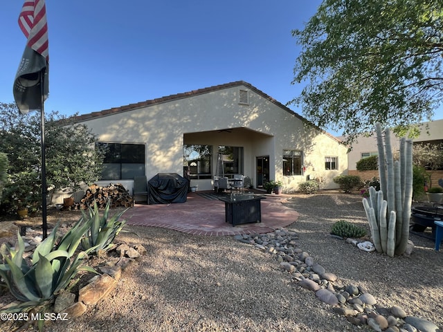 back of house featuring a patio area and stucco siding
