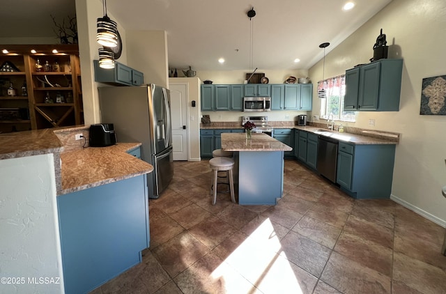 kitchen featuring appliances with stainless steel finishes, a breakfast bar, a kitchen island, vaulted ceiling, and blue cabinets