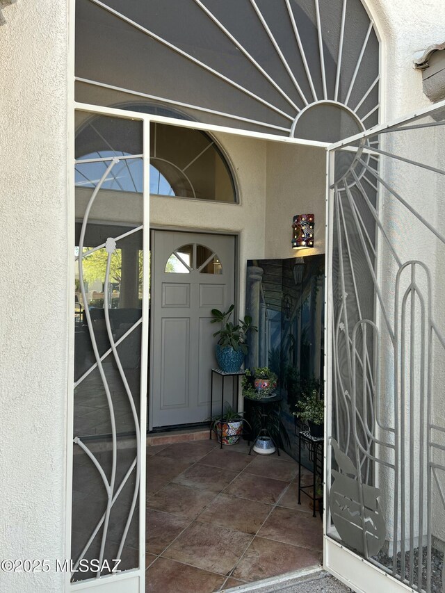 view of exterior entry with stucco siding