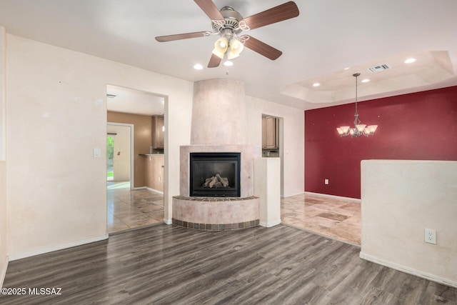 unfurnished living room featuring baseboards, recessed lighting, wood finished floors, and visible vents