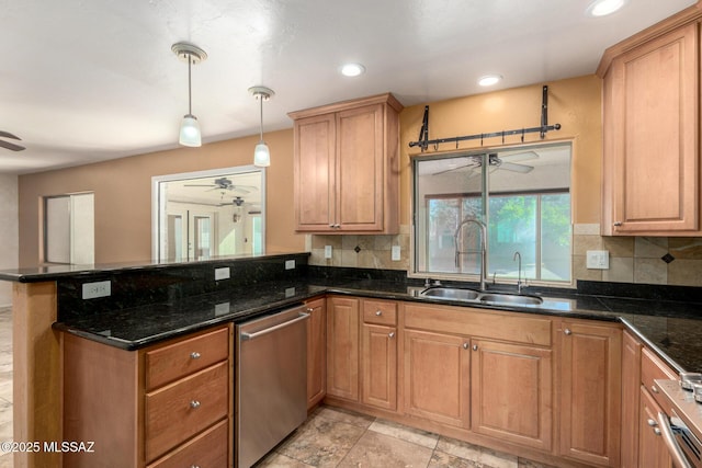 kitchen with a peninsula, a sink, ceiling fan, and dishwasher