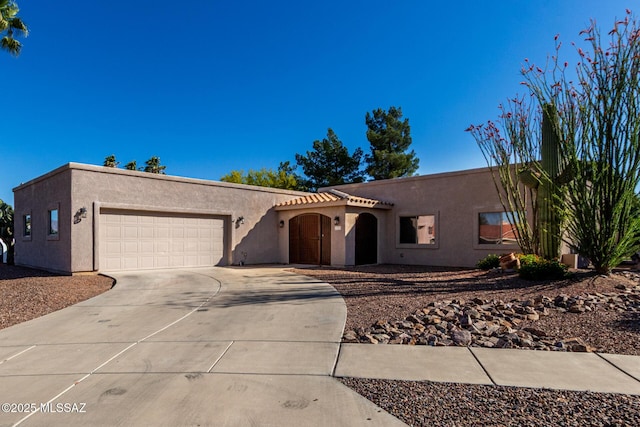 view of front of house featuring a garage, stucco siding, and concrete driveway