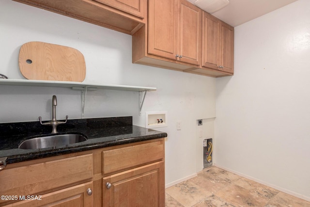 clothes washing area with hookup for an electric dryer, cabinet space, a sink, baseboards, and hookup for a washing machine