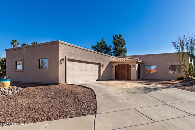 view of front of house featuring an attached garage, stucco siding, and concrete driveway