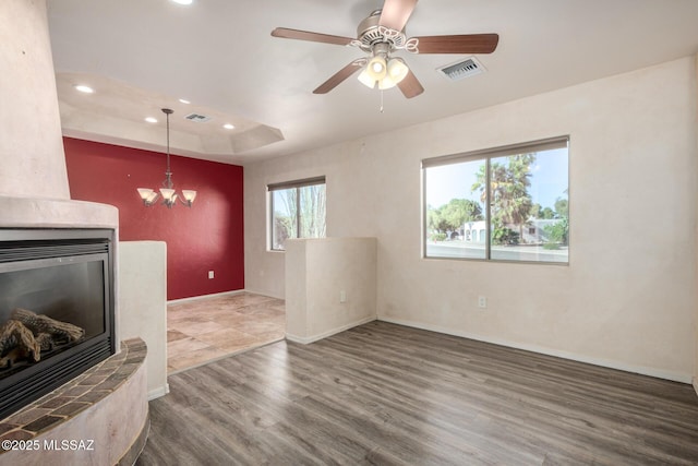 unfurnished living room featuring visible vents, recessed lighting, baseboards, and wood finished floors