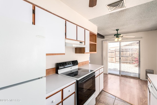kitchen featuring ceiling fan, white appliances, light countertops, under cabinet range hood, and visible vents