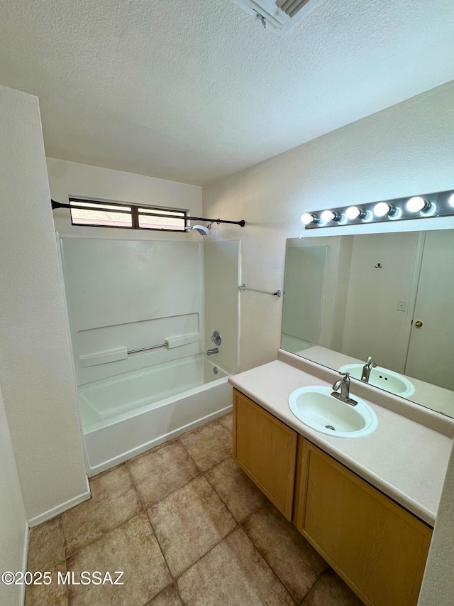 full bathroom with vanity, a textured ceiling, and tub / shower combination