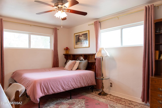 7302 E Placita Sinaloa, Tucson, AZ 85710 - bedroom featuring multiple windows, baseboards, and a ceiling fan