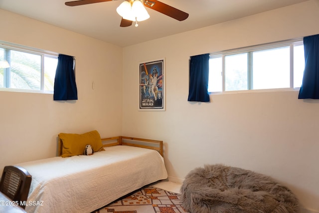 7302 E Placita Sinaloa, Tucson, AZ 85710 - bedroom with multiple windows, ceiling fan, and baseboards