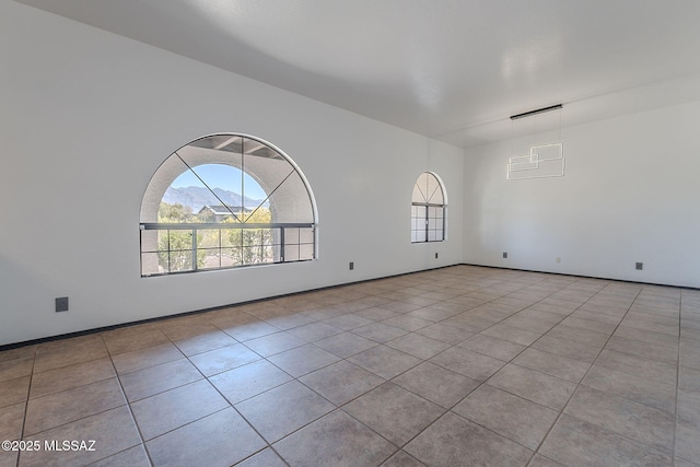 tiled spare room with a wealth of natural light