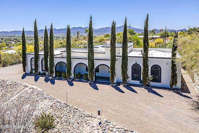 view of front of house with stucco siding and a mountain view