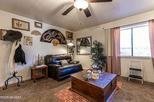 living room with a ceiling fan, a textured ceiling, baseboards, and carpet