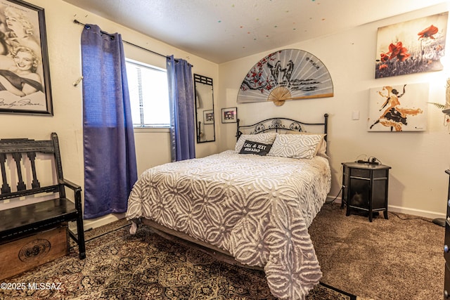 bedroom featuring baseboards and carpet