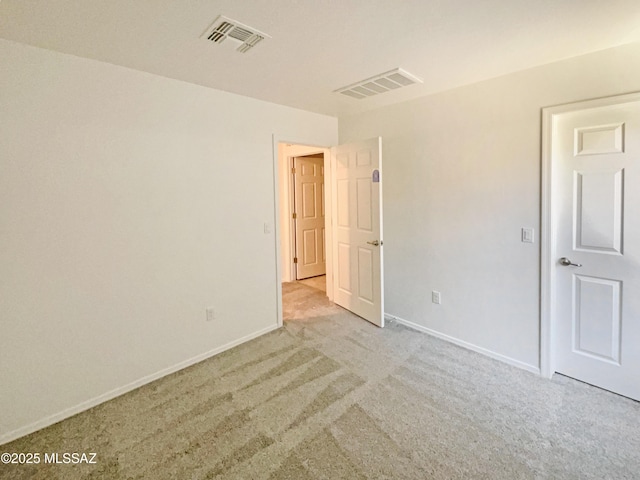 unfurnished bedroom featuring carpet flooring, baseboards, and visible vents