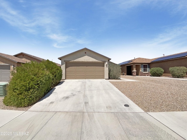 single story home with an attached garage, roof mounted solar panels, stucco siding, and concrete driveway