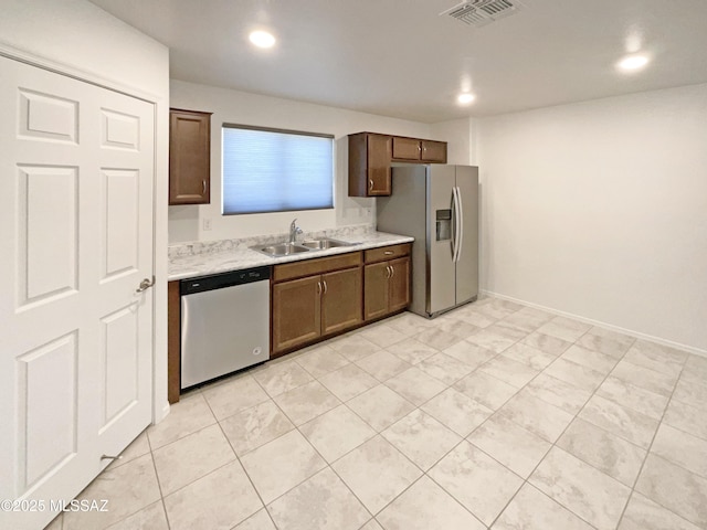kitchen with visible vents, recessed lighting, light countertops, a sink, and stainless steel appliances