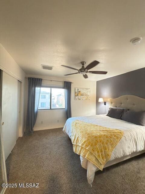 bedroom featuring a ceiling fan, visible vents, carpet, and a closet