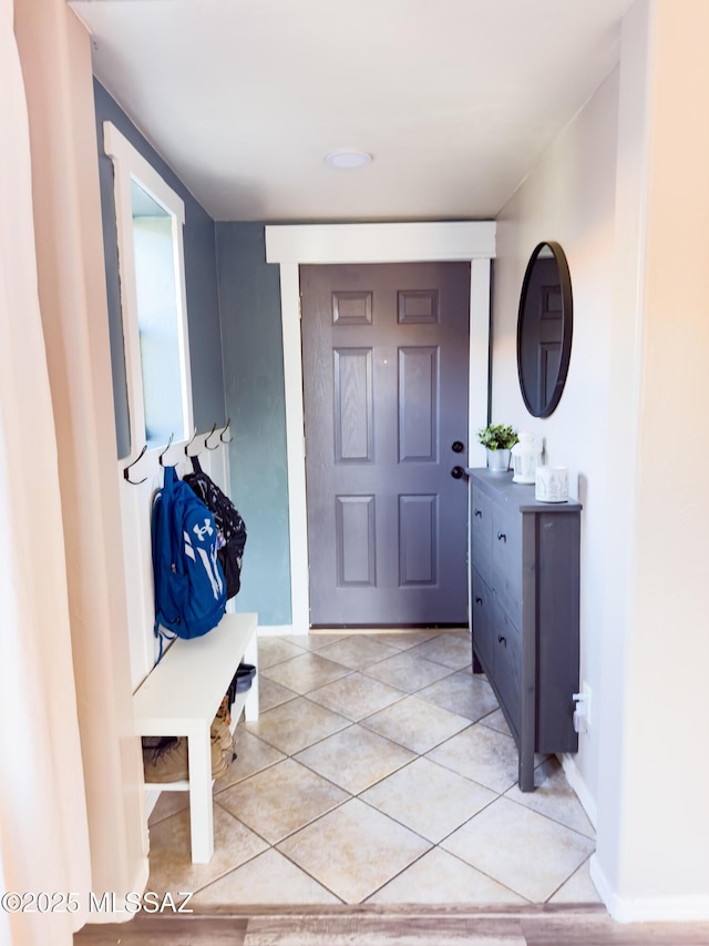 entryway featuring baseboards and light tile patterned floors