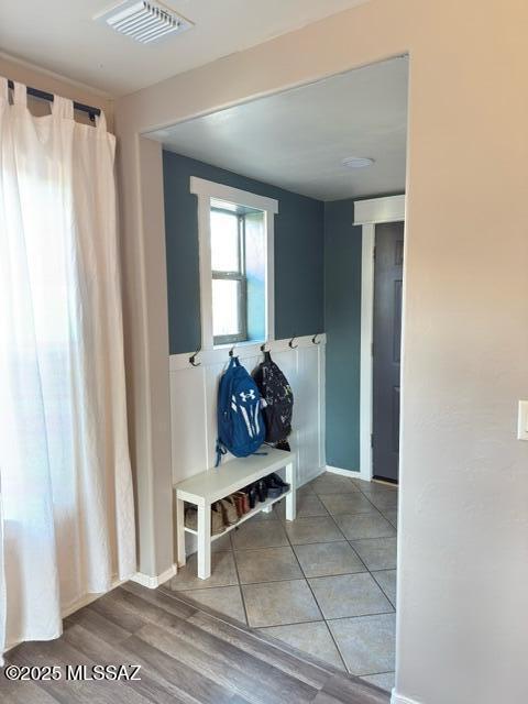 mudroom with baseboards, visible vents, and tile patterned floors