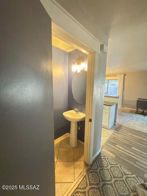 hall with baseboards and light tile patterned floors