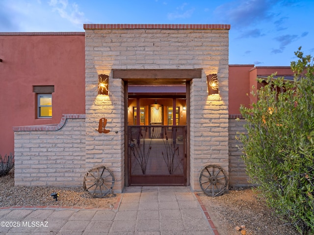 6300 N Abington Rd, Tucson, AZ 85743 - doorway to property featuring stucco siding and stone siding