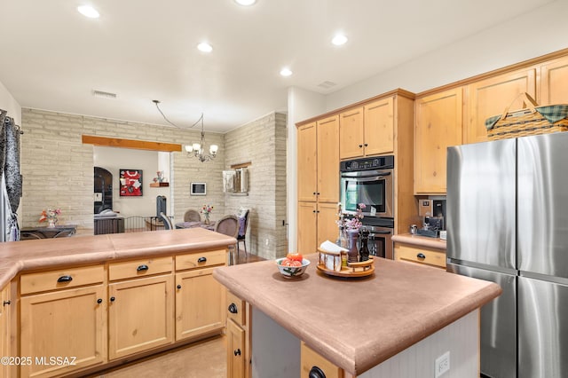 6300 N Abington Rd, Tucson, AZ 85743 - kitchen with stainless steel appliances, light brown cabinetry, a chandelier, light countertops, and a kitchen island