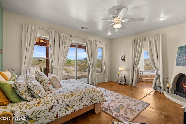 6300 N Abington Rd, Tucson, AZ 85743 - bedroom featuring access to outside, a lit fireplace, and a ceiling fan