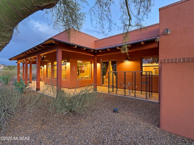 6300 N Abington Rd, Tucson, AZ 85743 - view of side of property with a patio, stucco siding, and metal roof