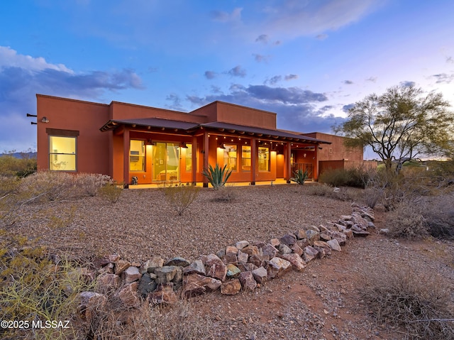 6300 N Abington Rd, Tucson, AZ 85743 - back of house at dusk featuring stucco siding