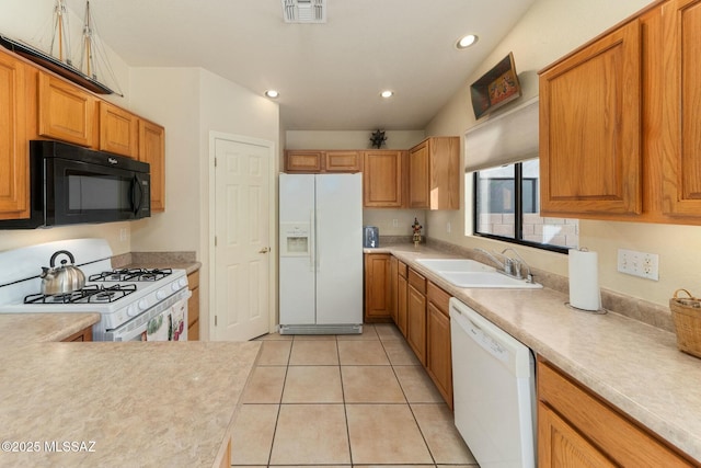 kitchen featuring visible vents, a sink, light countertops, recessed lighting, and white appliances