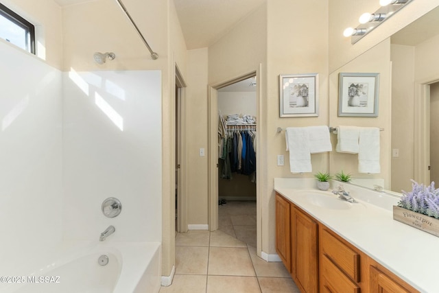 bathroom featuring tile patterned floors, bathing tub / shower combination, and vanity