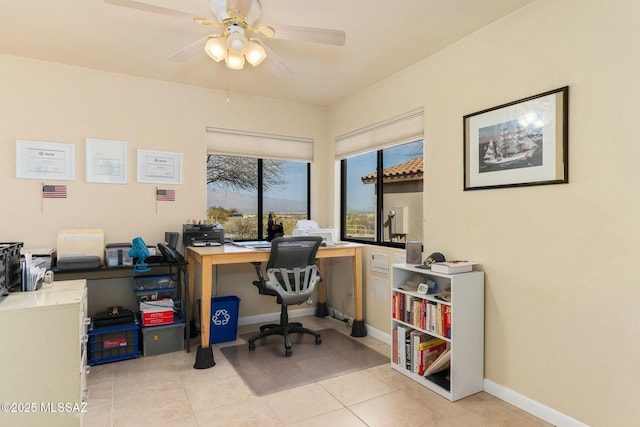office with a ceiling fan, baseboards, and light tile patterned floors