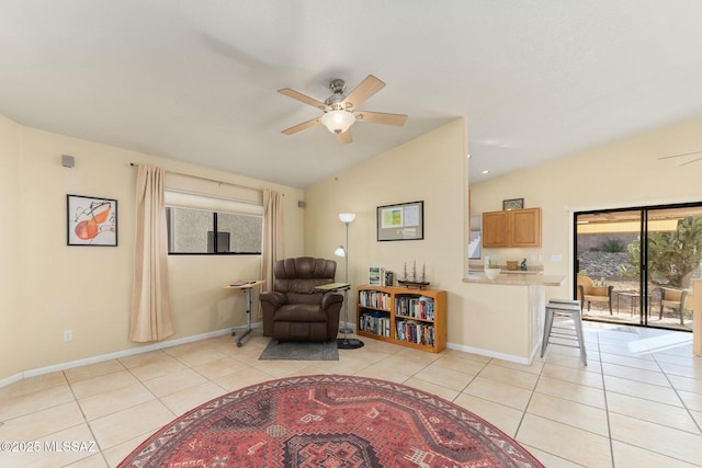 living area featuring a ceiling fan, light tile patterned floors, and lofted ceiling
