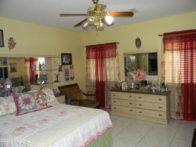 bedroom featuring visible vents, a ceiling fan, and marble finish floor