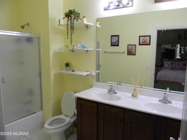 full bathroom with a sink, toilet, double vanity, and connected bathroom
