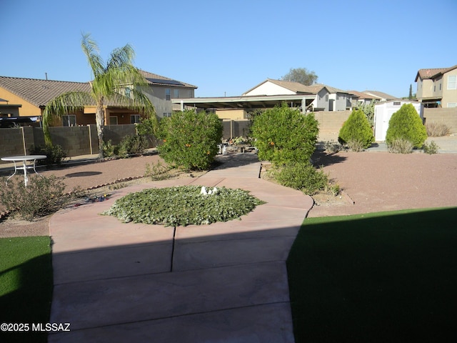 view of yard featuring fence and a residential view
