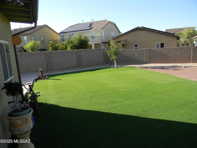 view of yard with a fenced backyard and a residential view