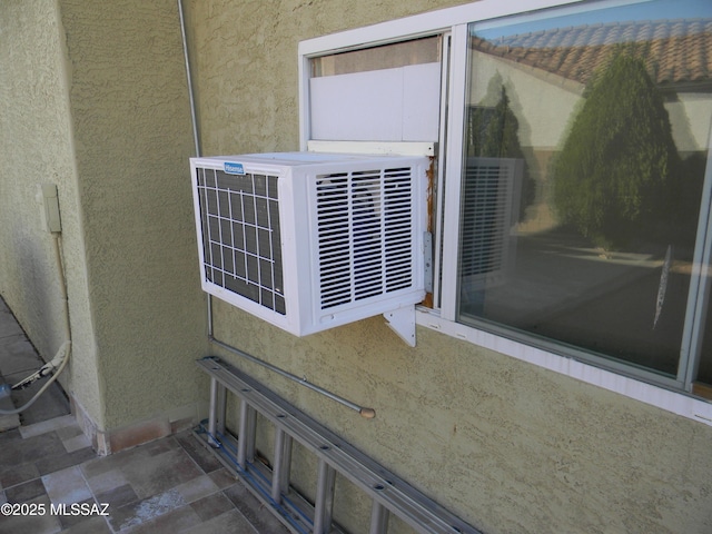 details with stucco siding and cooling unit