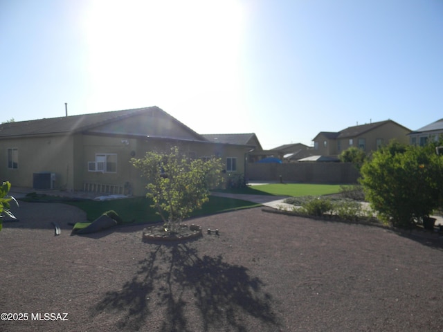 exterior space with fence and central AC