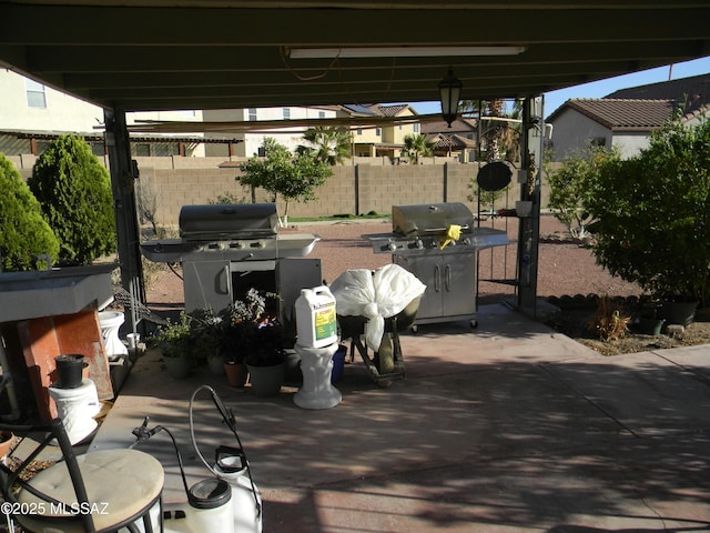 view of patio / terrace featuring fence and a grill