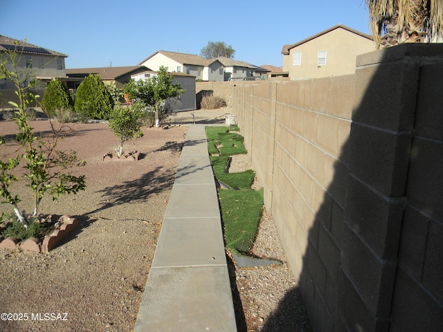 view of yard with fence and a residential view