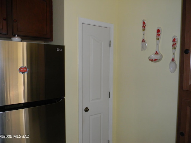 interior details featuring freestanding refrigerator and dark brown cabinetry