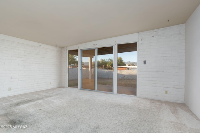 8133 E 6th St, Tucson, AZ 85710 - unfurnished room with carpet and brick wall