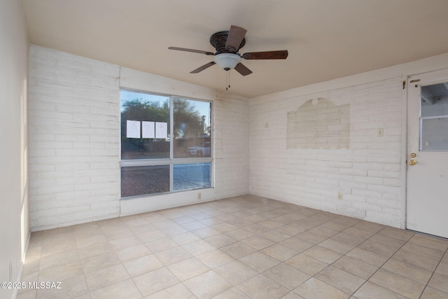 8133 E 6th St, Tucson, AZ 85710 - unfurnished room with brick wall and a ceiling fan