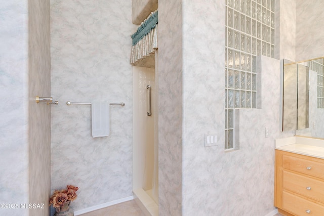 full bathroom featuring vanity and walk in shower