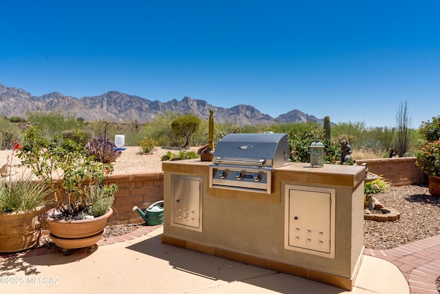 view of patio / terrace with grilling area, a mountain view, and area for grilling